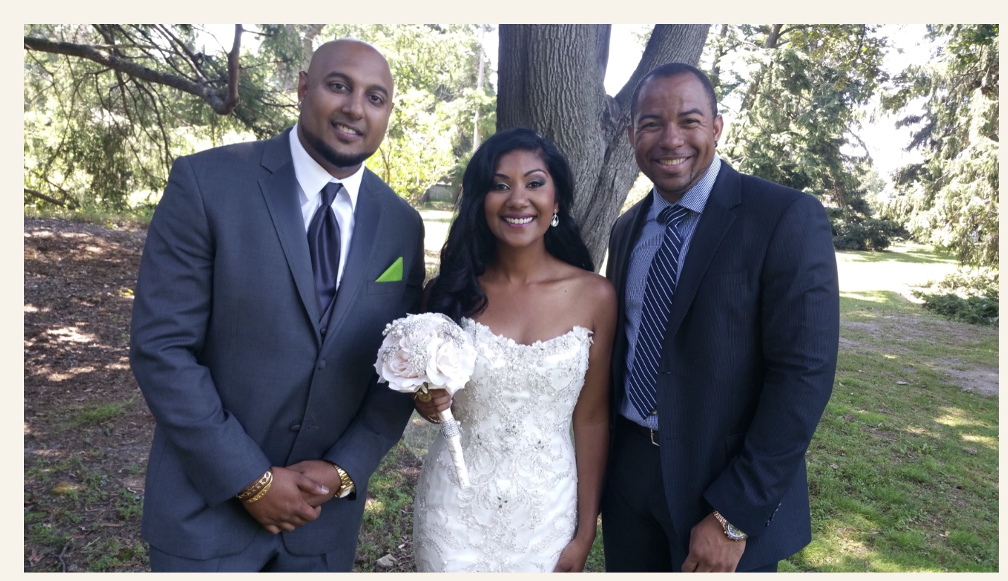 Wayde celebrating outdoors with a Black newlywed couple