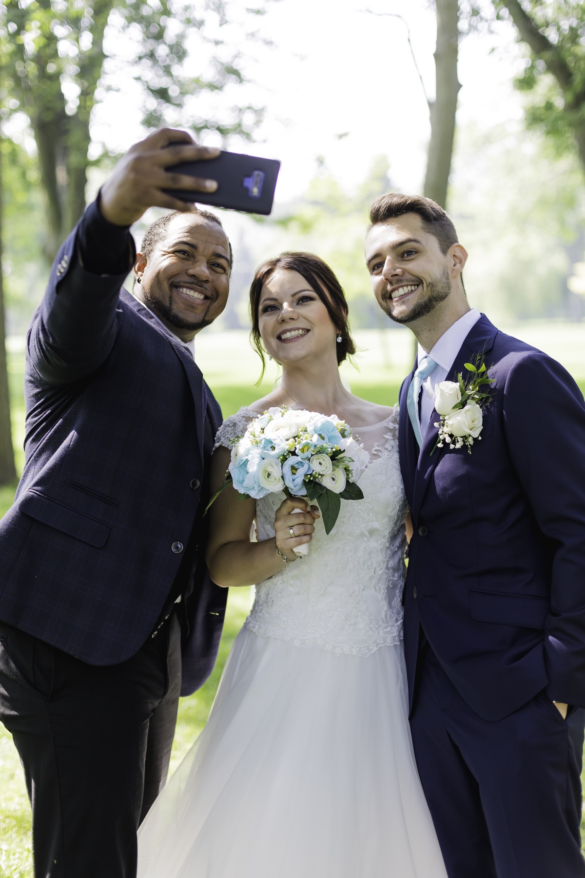 Wayde taking a joyful selfie with newlyweds