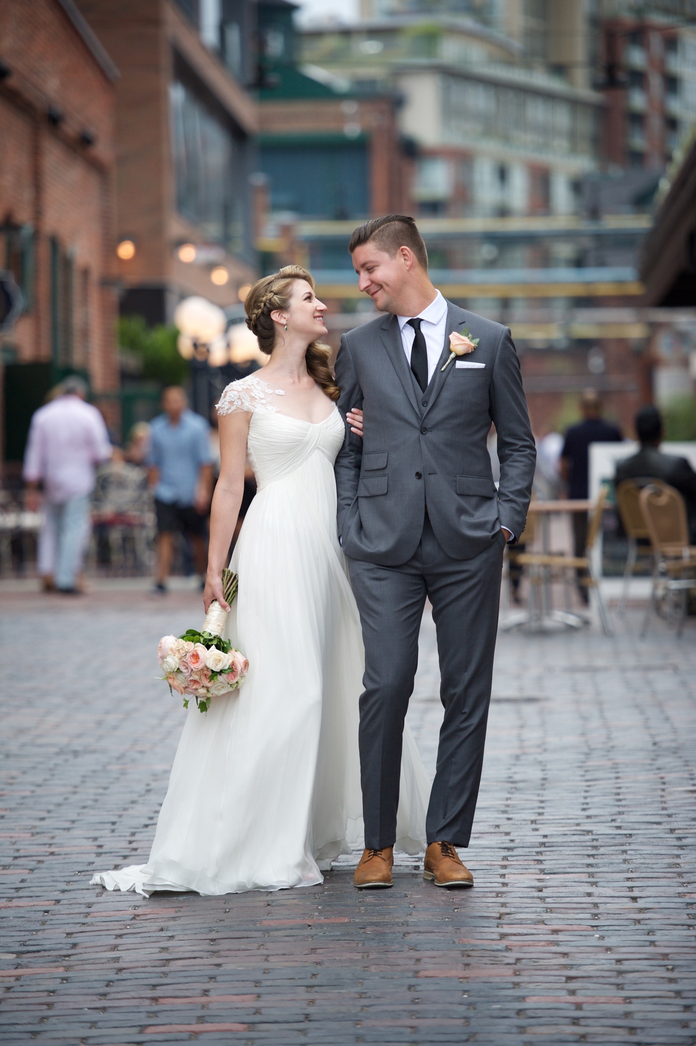 Newlyweds sharing a quiet moment on a city street