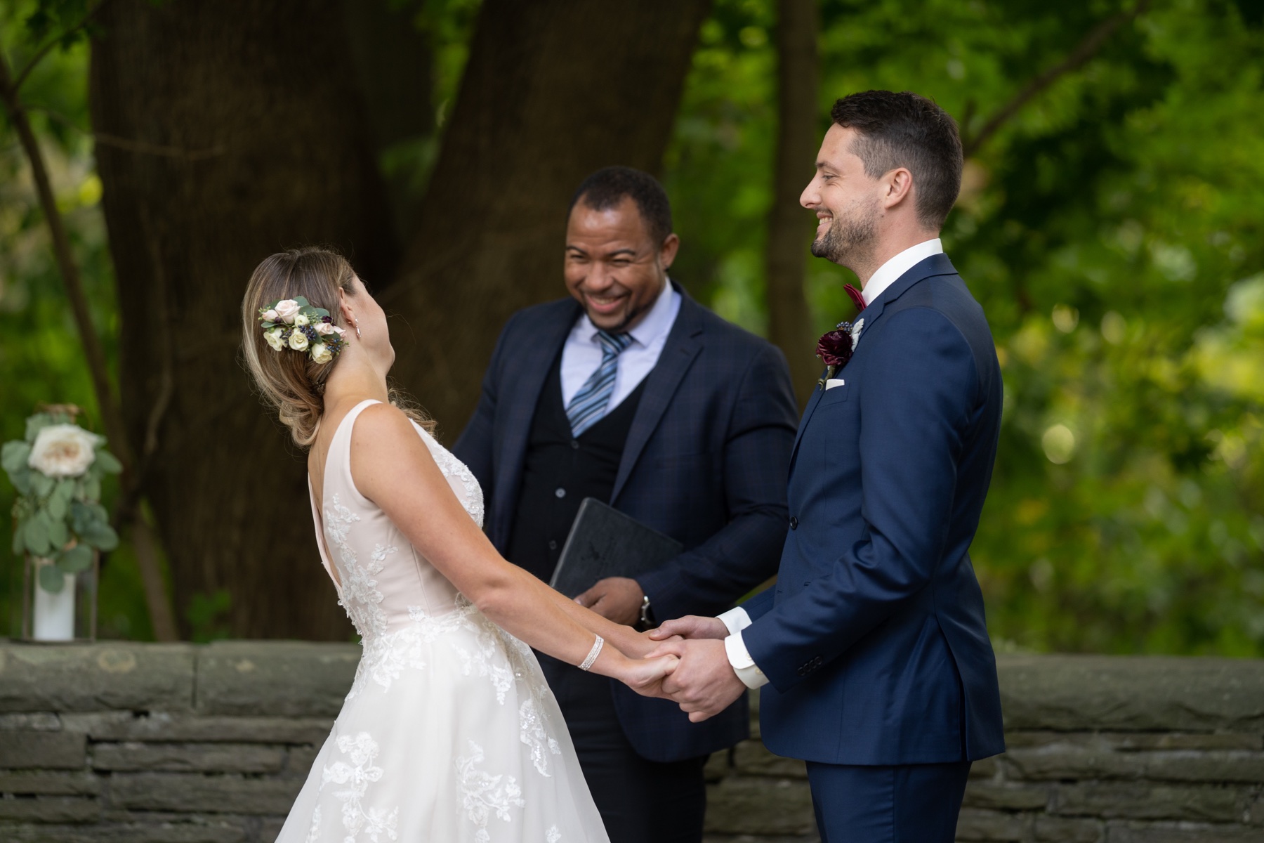 Wayde sharing a joyful moment with a couple during their outdoor ceremony