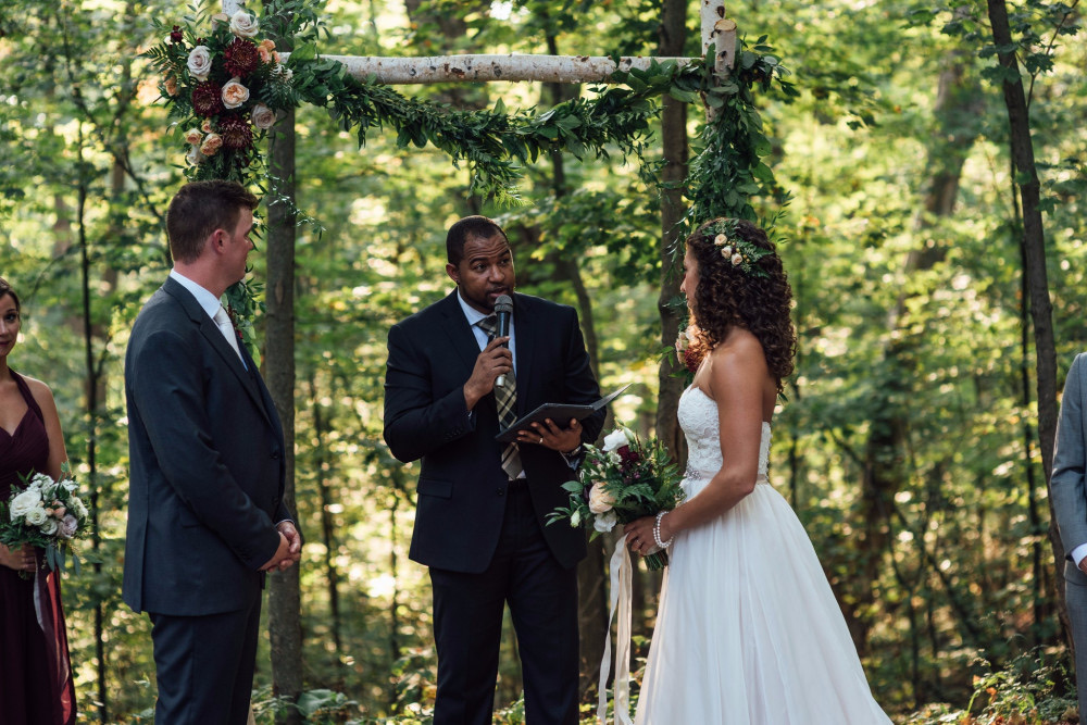 Wayde officiating an intimate woodland ceremony